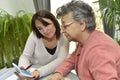 Home carer helping the elderly with paperwork
