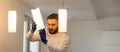 Home Ceiling Light Equipment Maintenance. Professional Electrician Worker. Royalty Free Stock Photo