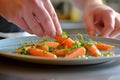 home chef garnishing sousvide cooked carrots on a dish Royalty Free Stock Photo