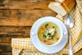 Home chicken soup with noodles, vintage spoon, tablecloth