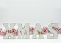 Home Christmas decoration on white background. Christmas fir branches, gift boxes with red ribbon, red decoration, sparkles and Royalty Free Stock Photo