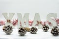 Home Christmas decoration on white background. Christmas fir branches, gift boxes with red ribbon, red decoration, sparkles and Royalty Free Stock Photo