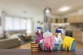 Home cleaning service concept with supplies. Close up of cleaning supplies in front of livingroom Royalty Free Stock Photo