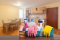 Home cleaning service concept with supplies. Close up of cleaning supplies in front of livingroom Royalty Free Stock Photo