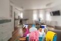 Cleaning service concept with supplies. Close up of cleaning supplies in front of livingroom Royalty Free Stock Photo