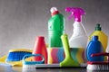 Variety cleaning products on gray background. Royalty Free Stock Photo