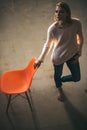 Home comfort with girl at chair. thoughtful woman at home with orange chair. lazy day at home. Frustrated woman standing Royalty Free Stock Photo