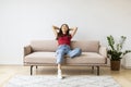 Home Comfort. Portrait Of Smiling Young Asian Woman Leaning Back On Couch Royalty Free Stock Photo