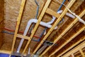 Home construction with hot and cold blue and red pex pipe layout in pipes and exposed beams Royalty Free Stock Photo