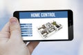 Home control remote on cell phone Royalty Free Stock Photo