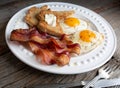 Bacon,sunnyside up eggs  and toast on a white plate Royalty Free Stock Photo