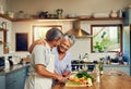 Home cooked happiness. Shot of a happy mature couple cooking a meal together at home. Royalty Free Stock Photo