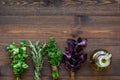 Home cooking with fresh greenery and organic oil on wooden table background top view mock up