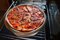 Home cooking pizza, peppers tomatoes mozzarella.