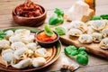 Home cooking - raw tortellini pasta with tomato pesto and sun-dried tomatoes and basil Royalty Free Stock Photo