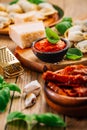 Home cooking - raw tortellini pasta with tomato pesto and sun-dried tomatoes and basil Royalty Free Stock Photo