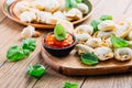 Home cooking - raw tortellini pasta with tomato pesto and sun-dried tomatoes and basil Royalty Free Stock Photo