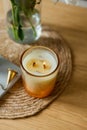 Home cozy interior. Candles, a bouquet of peonies in a glass vase on a wooden coffee table. Spring