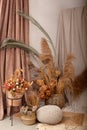 Home cozy interior of room in brown tones with dried flowers, pampas grass and branches in basket. Scandinavian design. Rustic. Bo Royalty Free Stock Photo