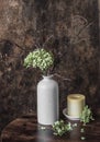 Home cozy still life - vase with dried hydrangea flowers and candle  on a wooden table Royalty Free Stock Photo