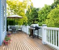 Home deck and patio with outdoor furniture and BBQ cooker with b Royalty Free Stock Photo