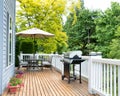 Home deck and patio with outdoor furniture and BBQ cooker Royalty Free Stock Photo
