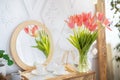 Home decor with bouquet of spring tulips in vase and tea set on table indoors, copy space Royalty Free Stock Photo