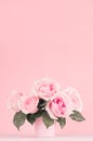 Home decor with flowers in romantic style - pastel pink roses bouquet in basket on white wood table, copy space. Royalty Free Stock Photo