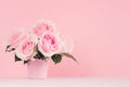 Home decor with flowers in romantic style - pastel pink roses bouquet in basket on white wood table, copy space. Royalty Free Stock Photo