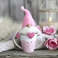 Home decorating ideas for Valentines Day. Cute pink valentine gnome in a cup. Hearts, flowers, wooden table