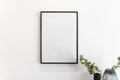Home decoration, empty black frame, poster, white canvas, mock up on a white wall, living room, template Royalty Free Stock Photo