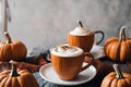 home decoration for halloween holiday, still life, latte and pumpkins on a table, festive background Royalty Free Stock Photo