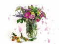 Beautiful  Wild flowers bouquet  rose hip petal  pink green yellow blue in glass vase and rose hip berry on white background Royalty Free Stock Photo