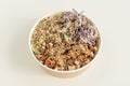 Home delivery container with bowl of chicken, vegetables, sunflower seeds, raisins, white and red quinoa,