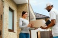 Home Delivery. Courier Delivering Package To Client Royalty Free Stock Photo