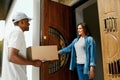 Home Delivery. Courier Delivering Package To Client Royalty Free Stock Photo