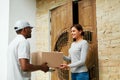 Home Delivery. Courier Delivering Package To Client Royalty Free Stock Photo