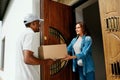 Home Delivery. Courier Delivering Package To Client Royalty Free Stock Photo