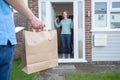 Home Delivery Of Takeaway Food Outside House Observing Safe Social Distancing During Coronavirus Covid-19 Pandemic Royalty Free Stock Photo