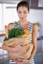 Home, delivery or woman with groceries or food, sale or discounts deal on nutrition in kitchen. Customer, offer or Royalty Free Stock Photo