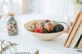 Home details decorations lying on the shelf. Wooden background. Loft style. Cosy rustic mood. Nuts in the jar. Straw basket Royalty Free Stock Photo