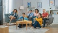 At Home Diverse Group Friends Watching TV Together, Eating Snacks and Drinking Beverage. Watching Royalty Free Stock Photo