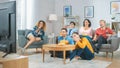 At Home Diverse Group Friends Watching TV Together, Eating Snacks and Drinking Beverage. Watching Royalty Free Stock Photo