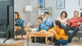 At Home Diverse Group Friends Watching TV Together, Eating Snacks and Drinking Beverage. Watching Royalty Free Stock Photo