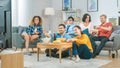 At Home Diverse Group Friends Watching TV Together, Eating Snacks and Drinking Beverage. They Prob Royalty Free Stock Photo