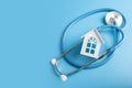 Home doctor, medical clinic with home visits, ambulance, house and medical stethoscope on blue background