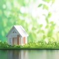 Home dreams Small model house against green bokeh background Royalty Free Stock Photo