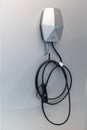 Home electric vehicle charging point mounted on wall with copy space