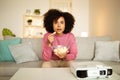 African American Lady Watching Movie Using Projector Eating Popcorn Indoors Royalty Free Stock Photo