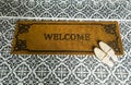 Home entryway with welcome mat and shoes. Royalty Free Stock Photo